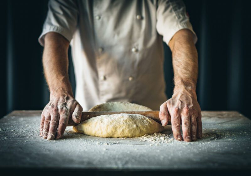 Baker rolling dough